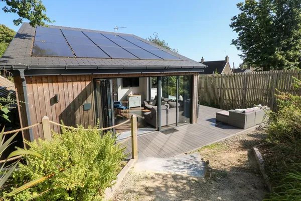 Cornerstones Brython cedar cabin with bifold doors and composite deck