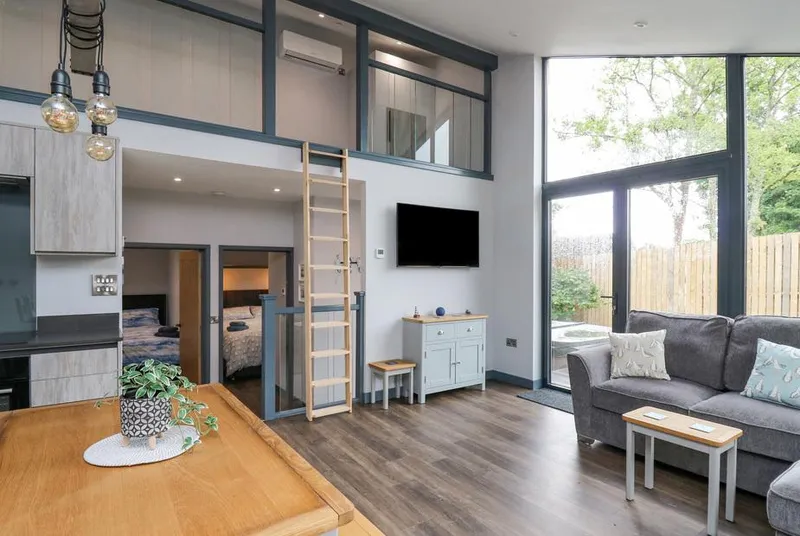 Cornerstones Brython double-height living space with mezzanine gallery and ladder