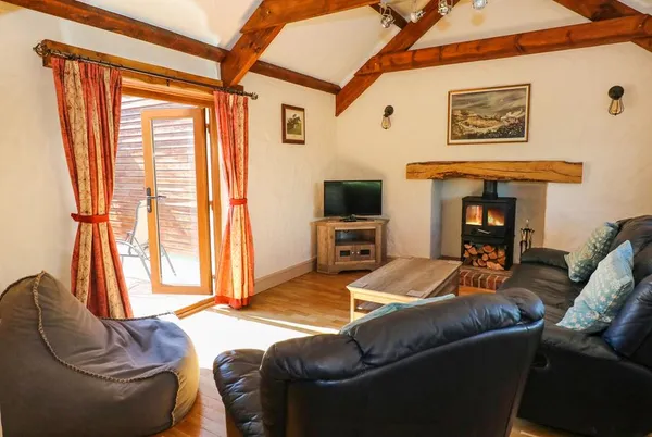 Stable Cottage lounge with log burner and French doors