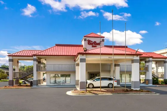 Hotel with a car parked in front of it