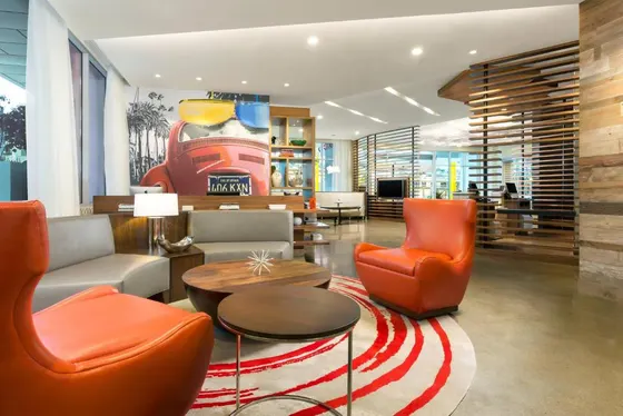 Lobby with orange chairs and a table
