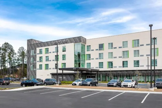 Office building with cars parked in a parking lot