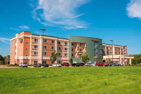 Large building with cars parked in a parking lot