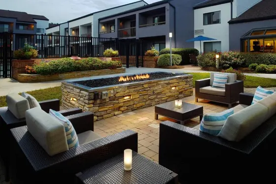 Patio with couches and a fire pit