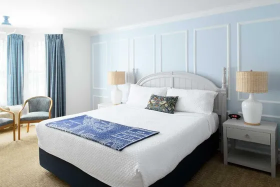 Bedroom with a bed with a blue and white bedspread