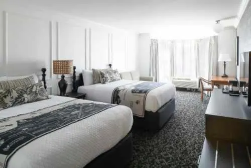 Hotel room with two beds and a desk