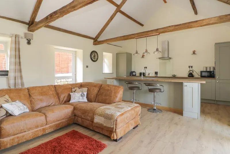 Crabtree Cottage open-plan living room with exposed oak beams and vaulted ceiling