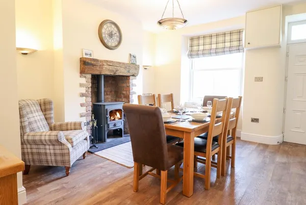 Craigside dining room with wood burner and set table