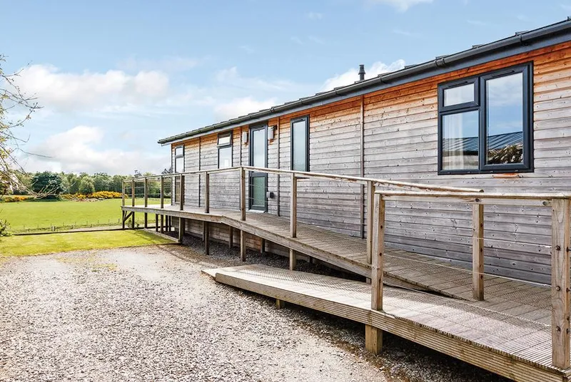 Cromarty Lodge exterior with ramped deck and countryside