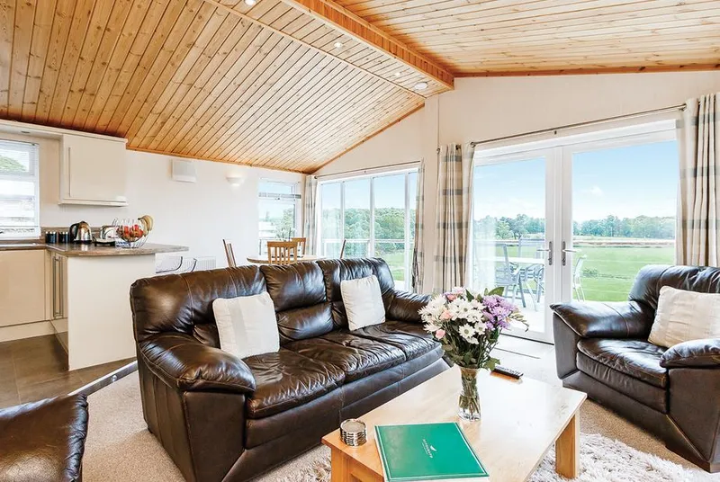 Cromarty Lodge open-plan living area with kitchen and deck doors