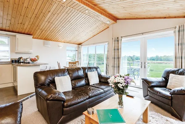 Cromarty Lodge open-plan living area with kitchen and deck doors