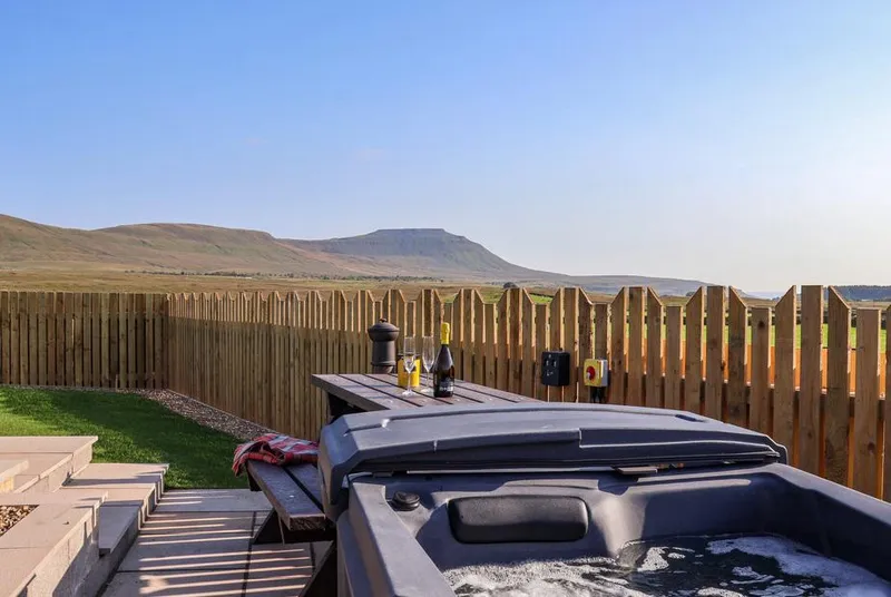 Curlew hot tub with Ingleborough fell backdrop at golden hour