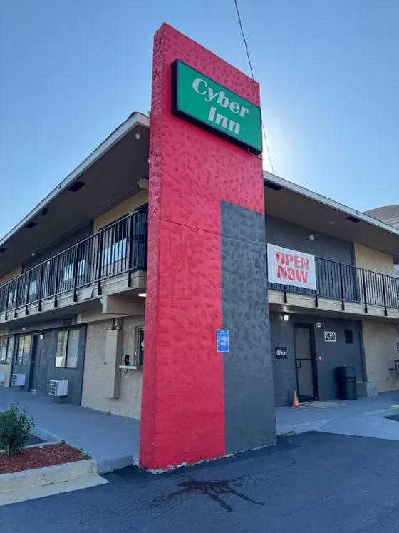 Red building with a sign for a Cyber Inn