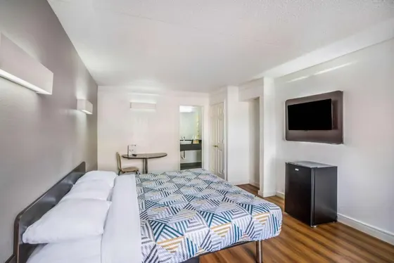 Bright room with wood floors and a geometric bedspread