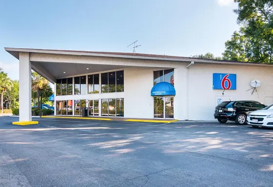 Gas station with a car parked in a parking lot