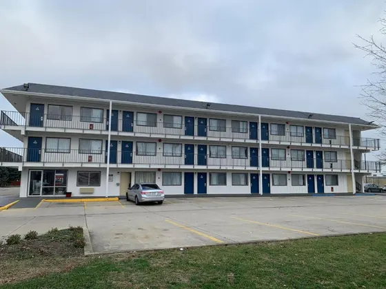 White motel with navy doors and outdoor walkways