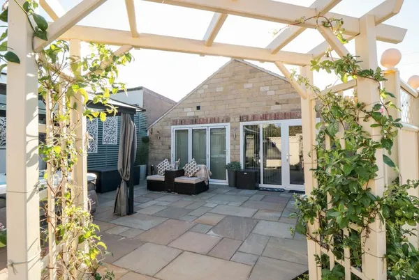 Garthgate Holiday Lodge stone lodge through climbing-plant pergola