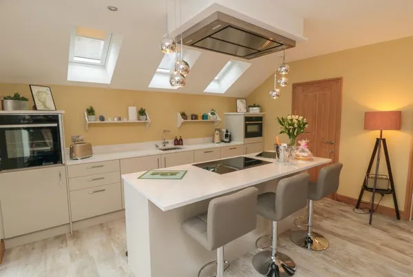 Garthgate Holiday Lodge kitchen with island, skylights and pendant lights