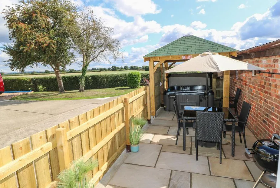 The Old Mill Hideaway covered hot tub patio with countryside views