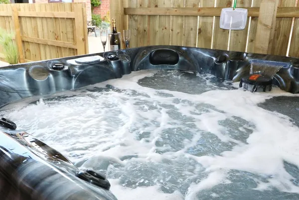 The Old Mill Hideaway bubbling hot tub close-up in garden