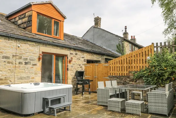 Middle Barn stone patio with outdoor dining and dormer window