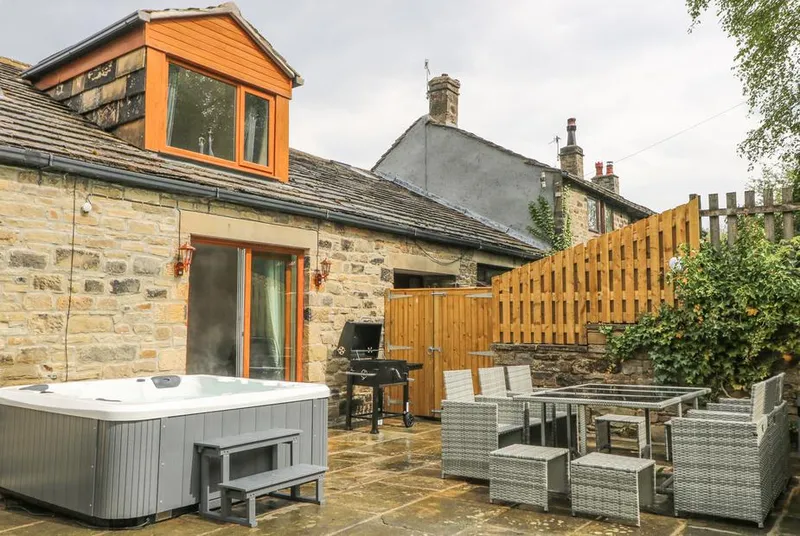 Middle Barn stone patio with outdoor dining and dormer window
