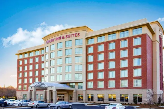 Large building with cars parked in a parking lot