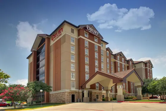 Multi-story brown hotel with a Drury sign