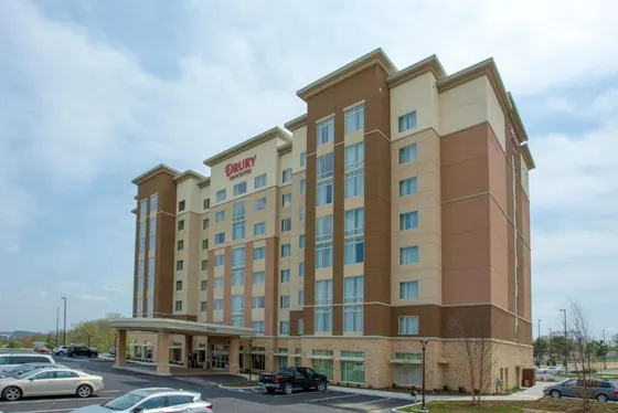 Rendering of a hotel with cars parked in a parking lot