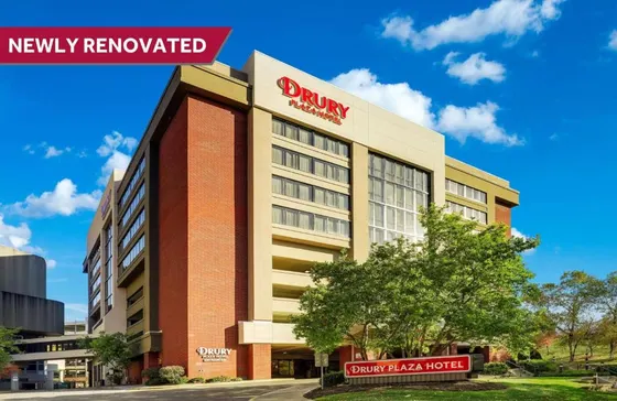 Brick and beige hotel with a red Drury Plaza sign