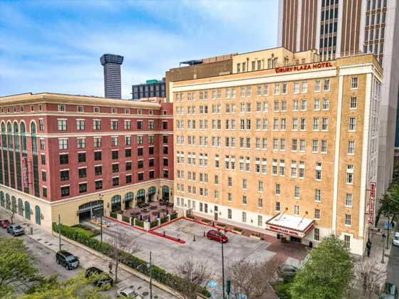 Tan and red brick hotel buildings with an outdoor patio