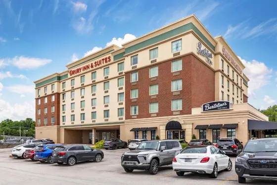 Hotel with cars parked in a parking lot