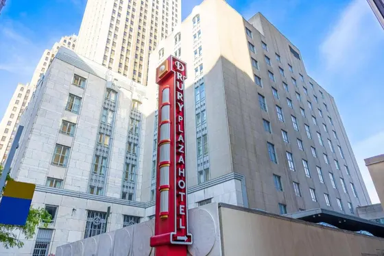Red hotel sign in front of a building