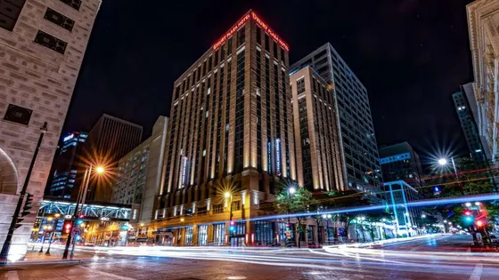 City street at night with a tall building