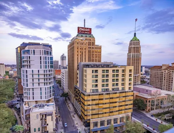 Skyline with a red Drury Plaza Hotel sign at twilight
