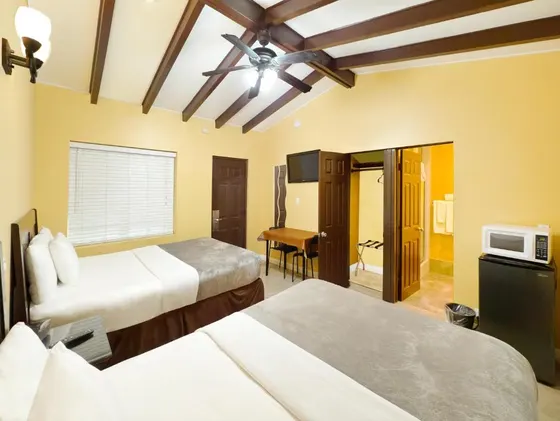 Hotel room with two beds and a tv