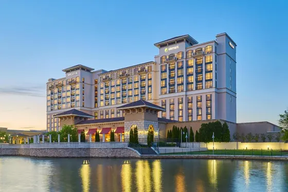 Rendering of a large building next to a body of water