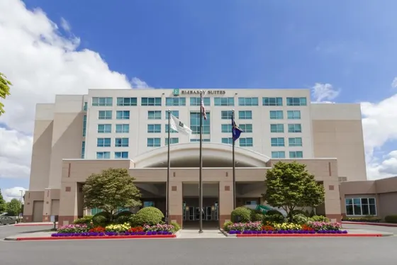 Large building with flowers in front of it