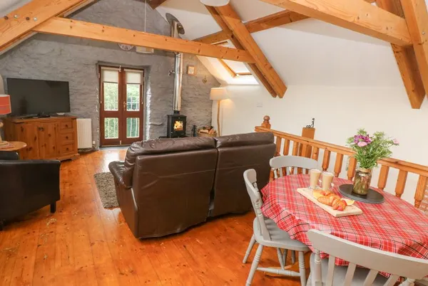 Y Cartws beamed mezzanine living space with log burner