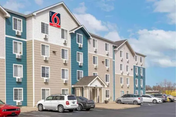 Large building with cars parked in a parking lot
