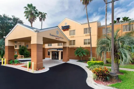 Rendering of the front of a hotel with palm trees
