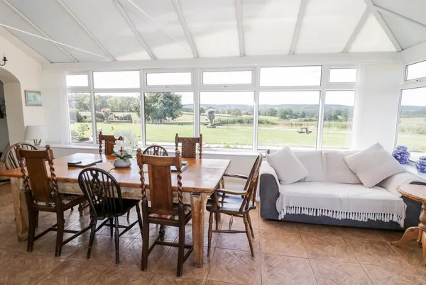 Far Coley Farm conservatory dining with panoramic countryside views