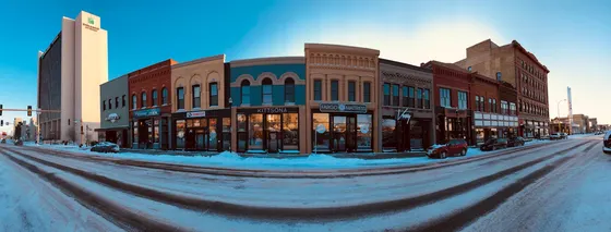 Snow-covered downtown Fargo street lined with historic storefronts