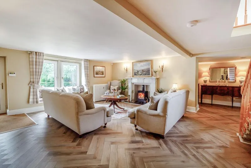 Fence House lounge with fireplace and herringbone floor