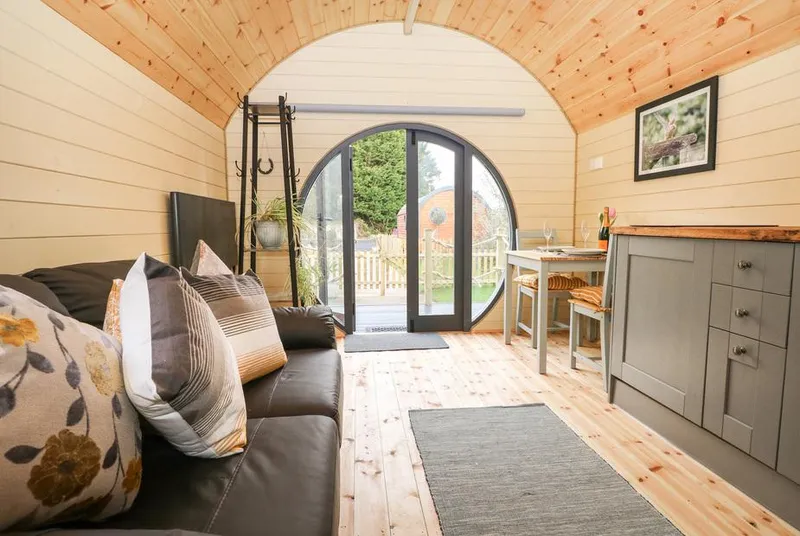 Filbert Pod living area with natural light through circular glass doors