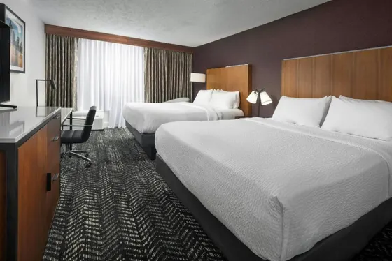 Hotel room with two beds and a television