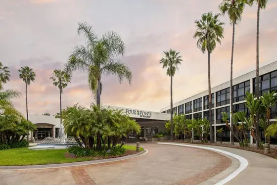 Building with palm trees in front of it