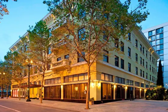 Building on a street with a tree in front of it