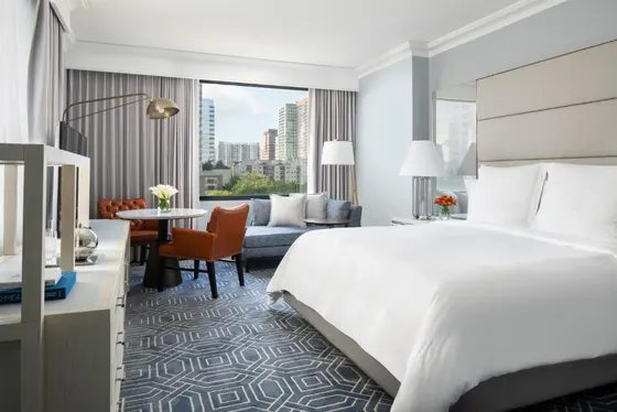 Hotel room with a large bed and a living room