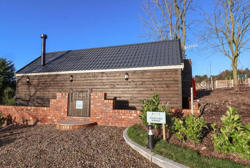 Foxes Den barn conversion front view with brick and timber cladding
